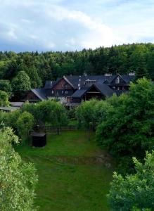 a view of a yard with houses and trees at Bacówka Biały Jeleń in Iwkowa