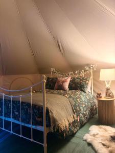 a bedroom with a bed in a tent at Woodview Caravan Site in Church Leigh