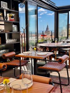 a restaurant with tables and chairs and a view of the city at RUZ Hotels in Istanbul