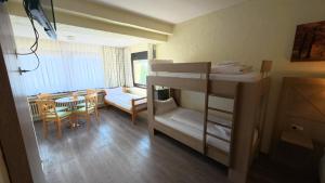 a dorm room with bunk beds and a dining room at Landhotel Eifelblick in Stadtkyll