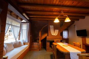 a living room with a couch and a table in a room at Cabañas Murmullo de Agua in Mar de las Pampas