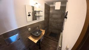 a bathroom with a sink and a shower at Landhotel Eifelblick in Stadtkyll +40 photos