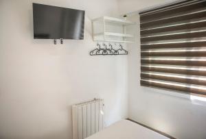 a room with a radiator and a tv on the wall at Next Stop Atocha in Madrid