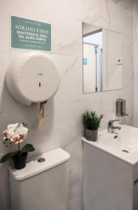 a white bathroom with a sink and a mirror at Next Stop Atocha in Madrid +25 photos
