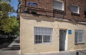 a brown building with a door on a street at Next Stop Atocha in Madrid