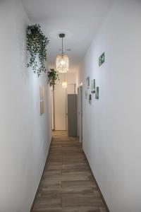 a hallway with a white wall and a light fixture at Next Stop Atocha in Madrid