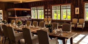 a dining room with a long wooden table and chairs at Grindal Salmon Lodge in Rennebu