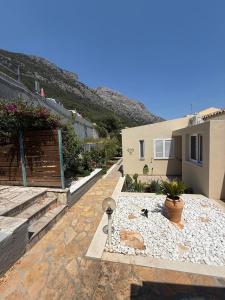 a house with a stone walkway next to a building at Villa Metaxa Barbati Beach Corfu in Barbati