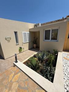 a house with a garden in front of it at Villa Metaxa Barbati Beach Corfu in Barbati