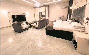 a hotel room with a bed and a flat screen tv at CRISPAN SUITES & EVENT CENTRE in Jos