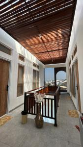 a balcony with a vase of flowers in a room at Naeera Inn Wonosobo Dieng in Kalibeber