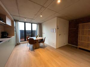 a kitchen and dining room with a table and chairs at Apartment for 4 guests in Bree in Bree +18 photos
