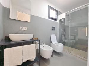 a bathroom with a sink and a toilet and a shower at Casina Pompiliano in Nardò