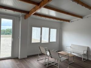 a room with chairs and a table and a table and windows at Lar de Luz in Palas de Rei +57 photos