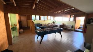 a living room with a table in the middle of a room at Landhotel Eifelblick in Stadtkyll