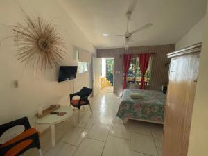 a bedroom with a bed and a table and chairs at Villa Mar Sosua in Sosúa