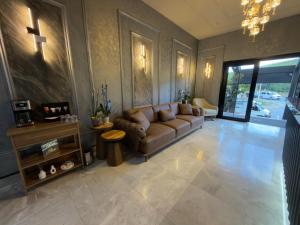 a living room with a couch and a cross on the wall at Alabi Hotels in Istanbul