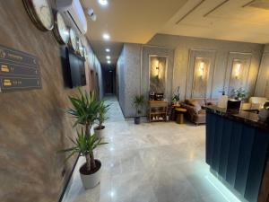 a lobby with potted plants on the wall at Alabi Hotels in Istanbul