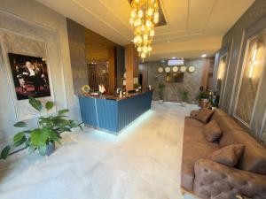 a lobby with a couch and a bar in the background at Alabi Hotels in Istanbul