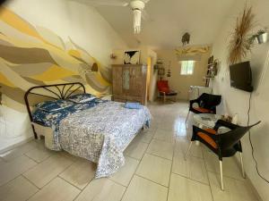 a bedroom with a bed and a table and chairs at Villa Mar Sosua in Sosúa +80 photos