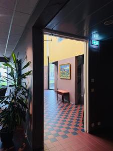 a hallway with a door open to a room with a bench at Hótel Bifröst in Bifrost
