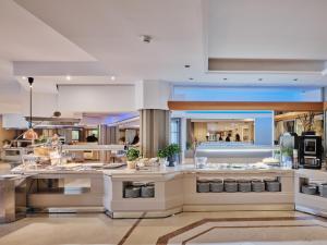 a large kitchen with a lot of food at Acacia Resort in Campofelice di Roccella