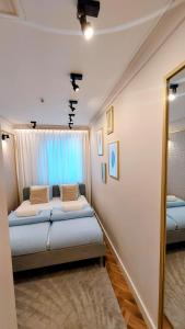a bedroom with two beds and a window at THE ONE Apartment in Tomaszów Mazowiecki