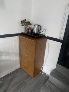 a small wooden cabinet with a pot on top of it at Modern Studio with Free Parking near sea-station-shops in Portslade