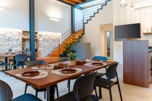a dining room with a large wooden table and chairs at Antiche Cantine Bed & Breakfast in Alcamo