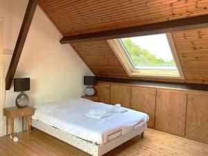 a bedroom with a bed with a large window at Phare - SAINT HILAIRE DE RIEZ in Saint-Hilaire-de-Riez +17 photos