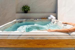 a person laying in a bathtub with a sink at Antiche Cantine Bed & Breakfast in Alcamo +48 photos
