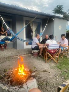 a group of people sitting around a fire at Santo Cristo in Tena