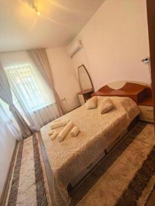 a bedroom with a bed with two towels on it at Hristean Apartment Petrich in Petrich +11 photos
