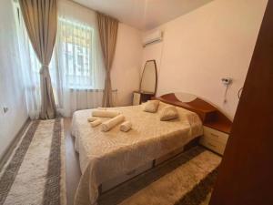 a bedroom with a bed with towels on it at Hristean Apartment Petrich in Petrich