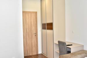 a room with a desk and a chair next to a door at Villa Blanco in Mostar +11 photos
