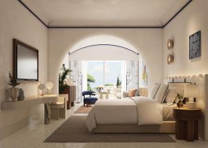a bedroom with a bed and a living room at Jumeirah Capri Palace in Anacapri