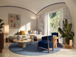 a living room with a couch and a table at Jumeirah Capri Palace in Anacapri