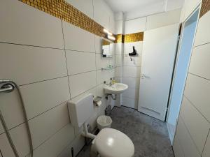a bathroom with a toilet and a sink at Art Rock Airport in Cologne +53 photos