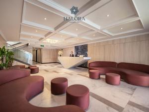 a lobby with red leather furniture and a counter at Halora Kairos Cruise in Ha Long