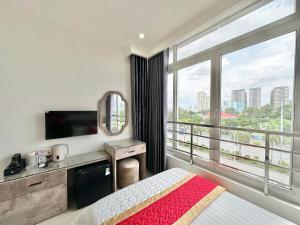 a hotel room with a bed and a large window at Phú Gia Hotel 464 Nguyễn Văn Linh in Ho Chi Minh City