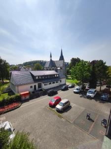 a large building with cars parked in a parking lot at Fewo Gloria in Altenbeken