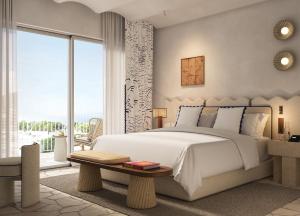 a bedroom with a white bed and a large window at Jumeirah Capri Palace in Anacapri
