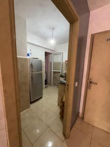 an open door to a kitchen with a refrigerator at Perfect Stay Apartment 10 min to airport ibn battouta and beach in Tangier