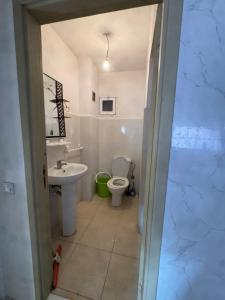 a bathroom with a toilet and a sink at Perfect Stay Apartment 10 min to airport ibn battouta and beach in Tangier +6 photos