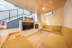a living room with a couch and a tv at Casa do primo Zeca in Ponte da Barca