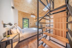 a bedroom with a bed and wooden walls at Casa do primo Zeca in Ponte da Barca +36 photos