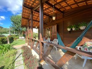 a porch of a house with hammocks on it at Paz na Serra Teresopolis Pet Friendly in Teresópolis