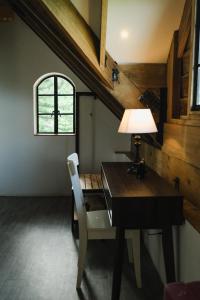 an attic room with a desk and a window at The Old Country Stone House in Cebu City +40 photos