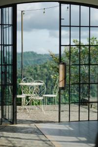 a table and chair sitting on top of a balcony at The Old Country Stone House in Cebu City