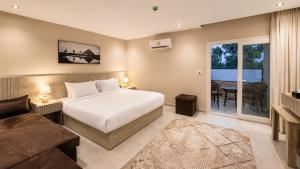 a bedroom with a bed and a living room at Dar Pyramids Boutique in Cairo